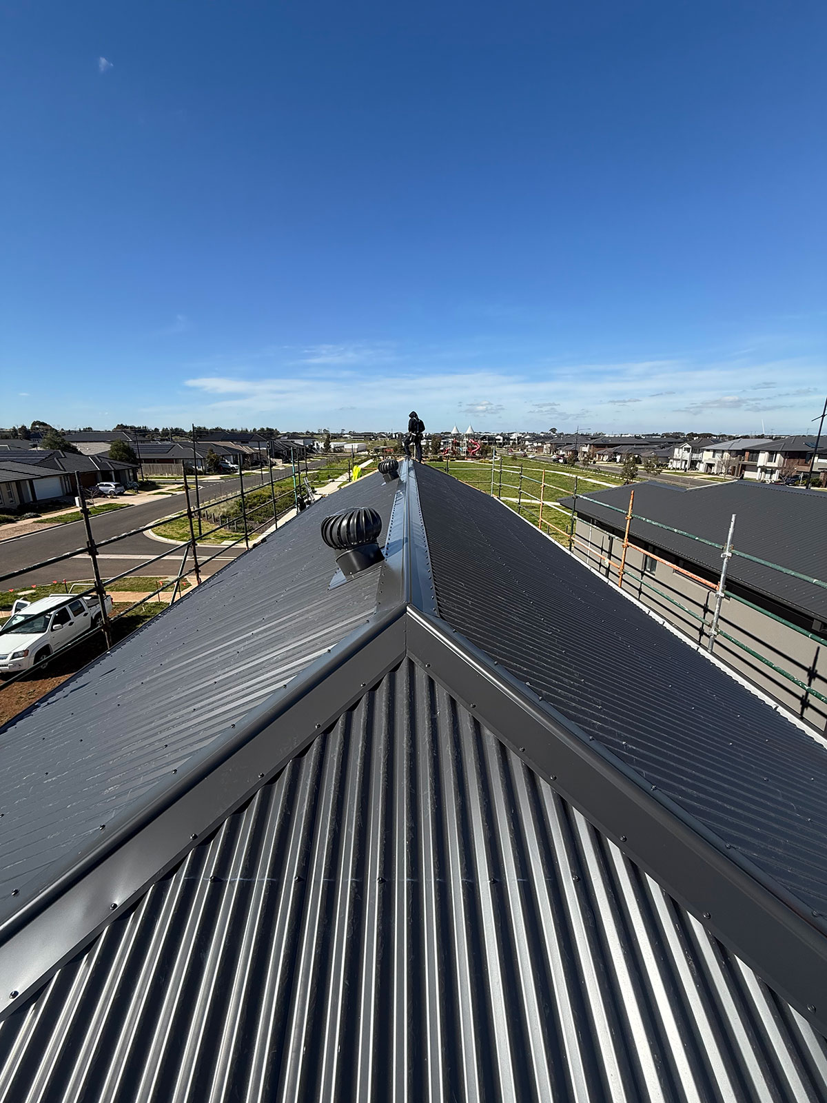 Completed dark grey Colorbond roof on a new Melbourne townhouse